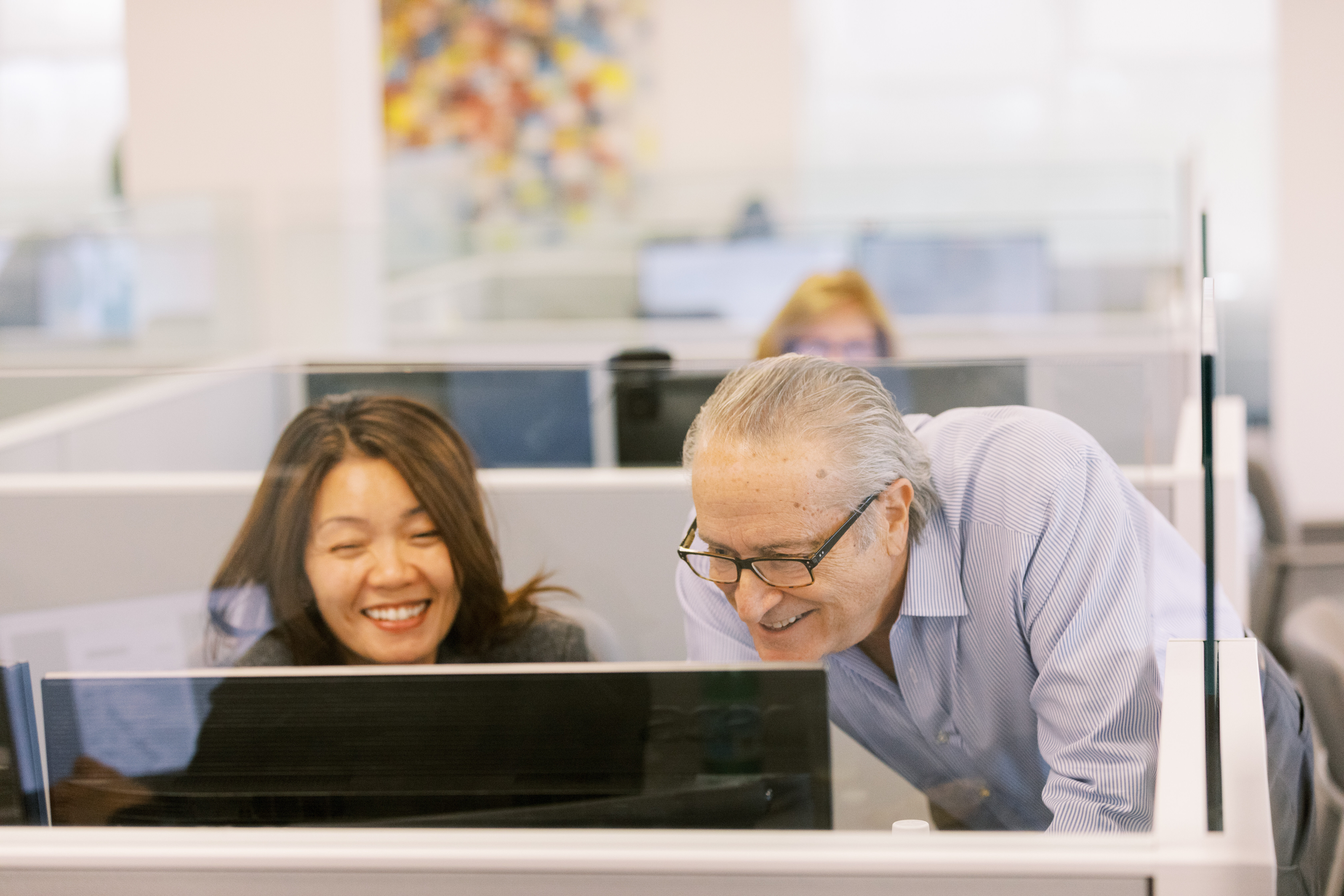 two revonary accountants looking at a screen